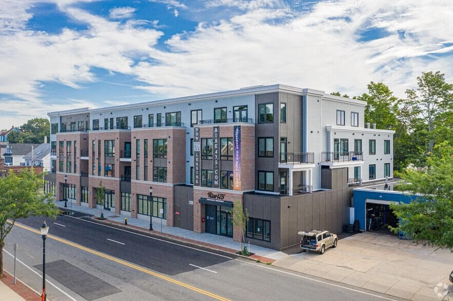 An apartment building on the corner of a street.