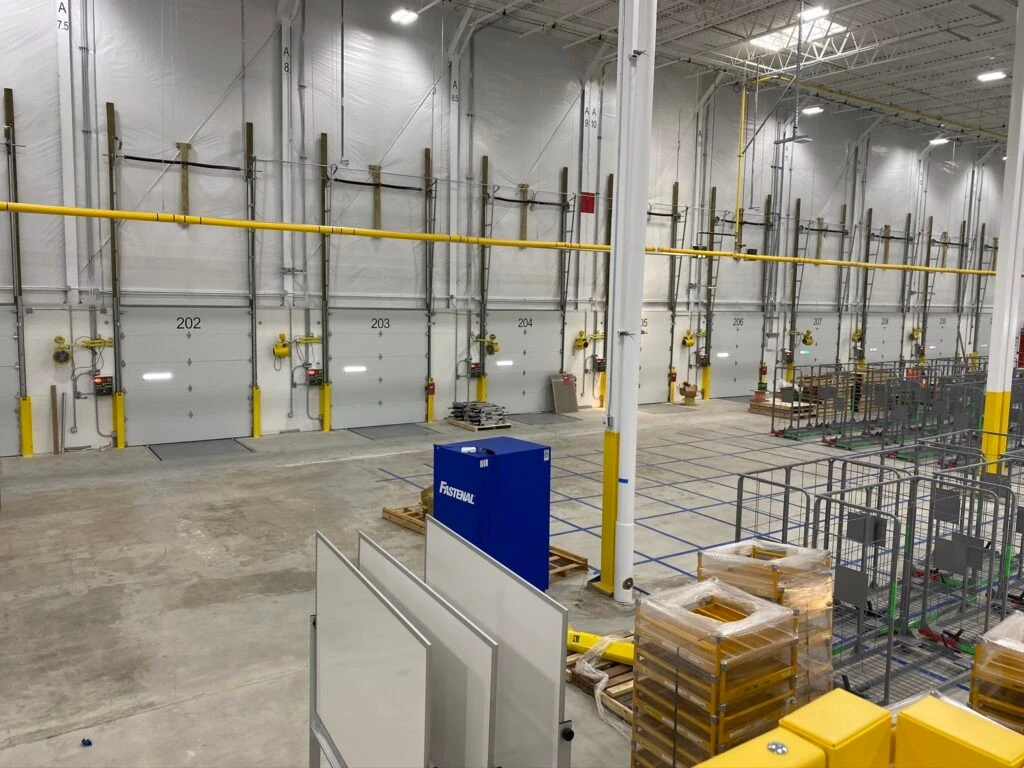 The inside of a large warehouse with yellow boxes.