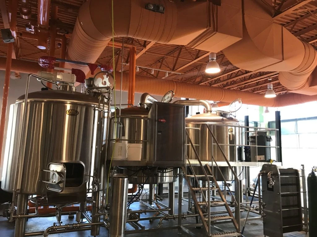 A brewery with a lot of tanks and pipes.