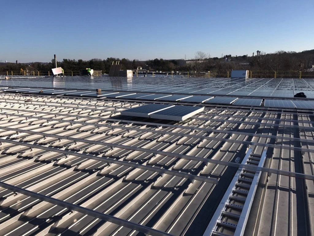A metal roof with solar panels on it.