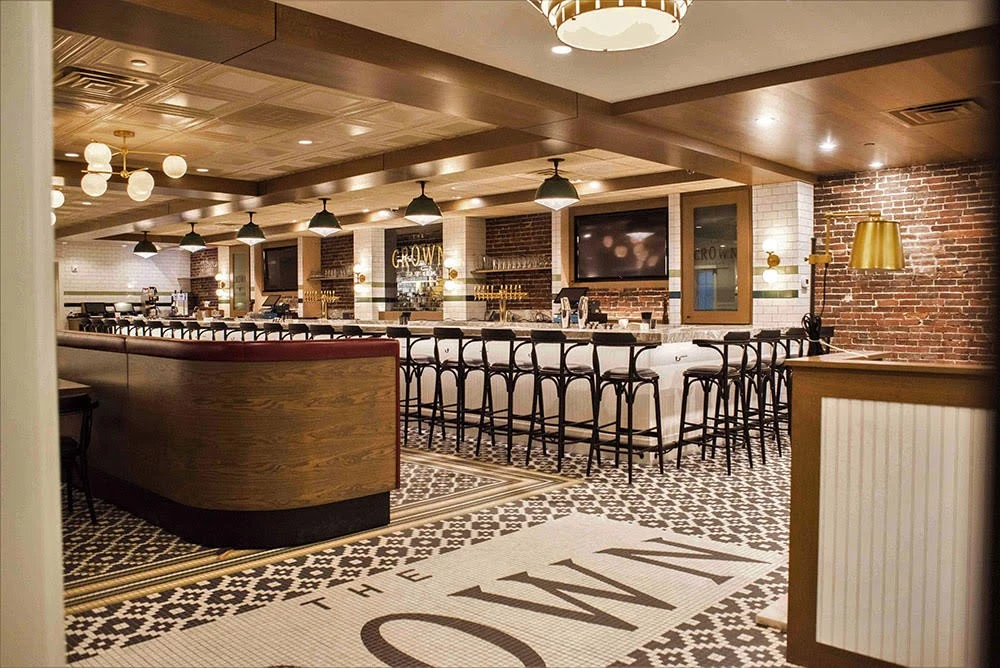 The interior of a restaurant with a brick floor.