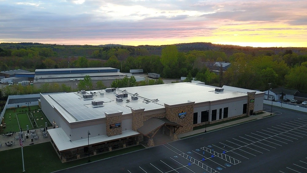 An aerial view of a building at sunset.