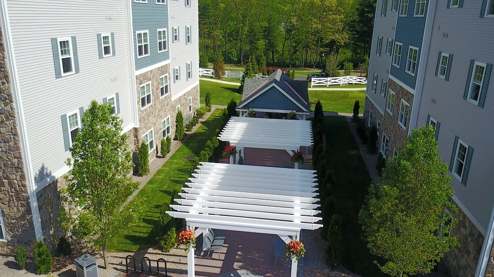 An aerial view of an apartment complex with a walkway.