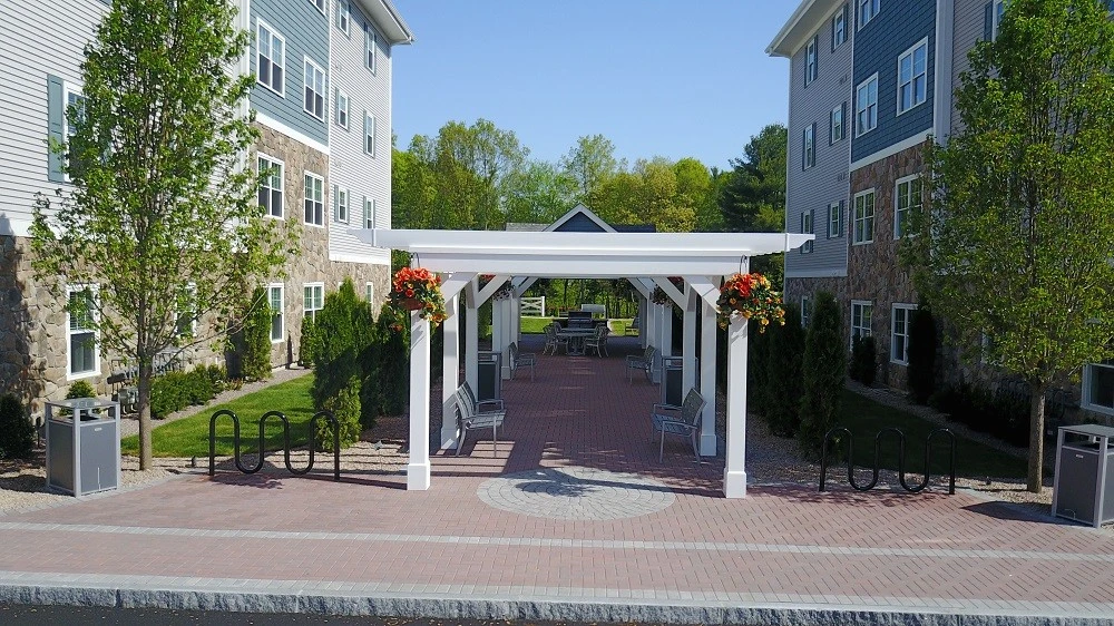 A walkway leading to an apartment complex.