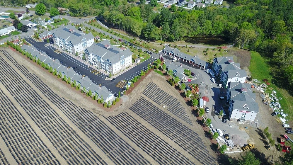 An aerial view of an apartment complex with solar panels.