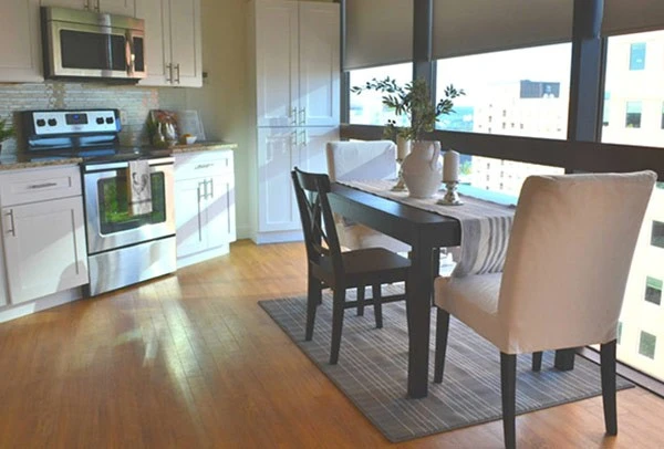 A kitchen with a table and chairs.