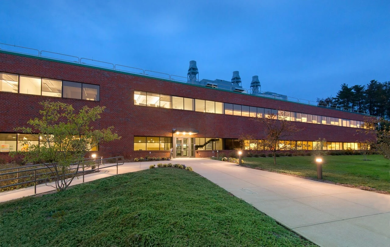 The exterior of a brick building at dusk.