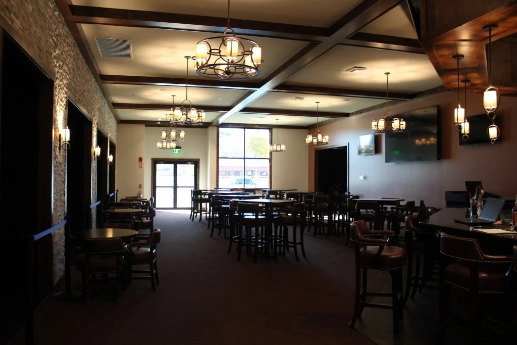 A room with a lot of tables and chairs.