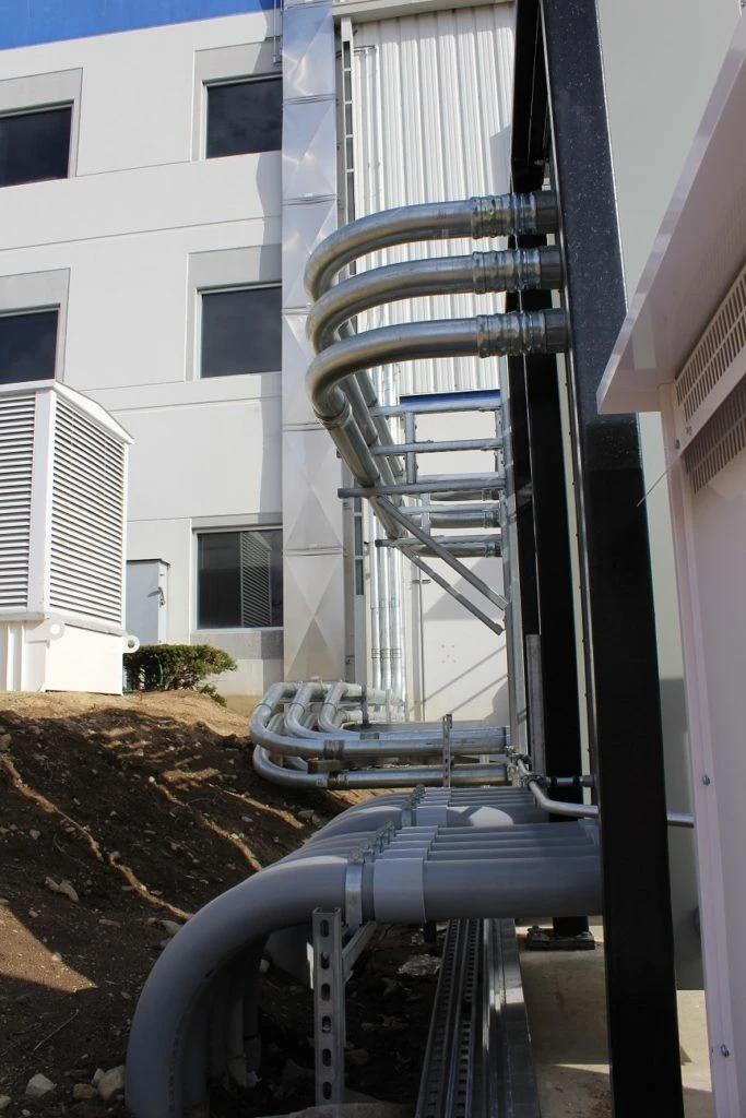 A building with pipes on the side of it.