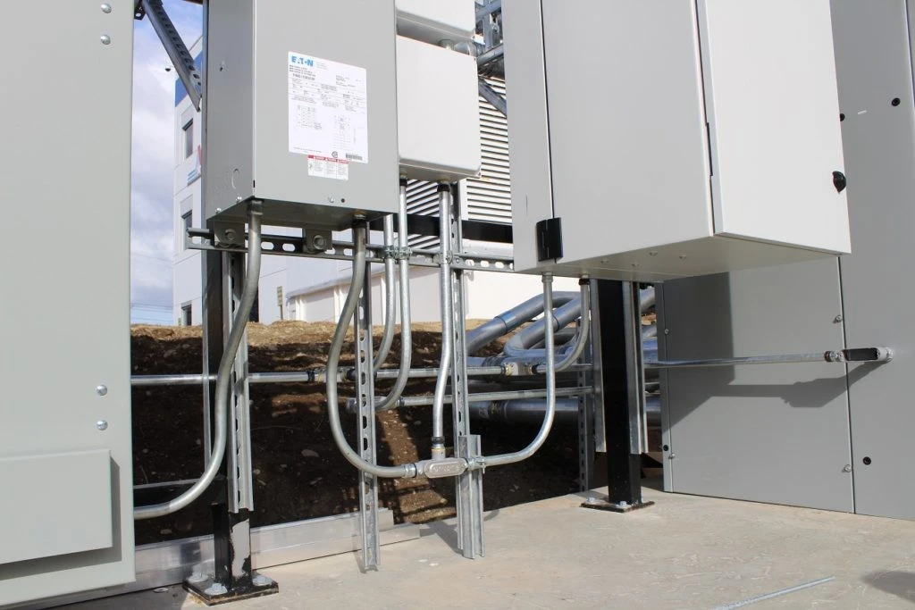 A group of metal boxes with wires attached to them.