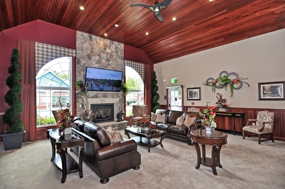 A living room with a fireplace and a flat screen tv.
