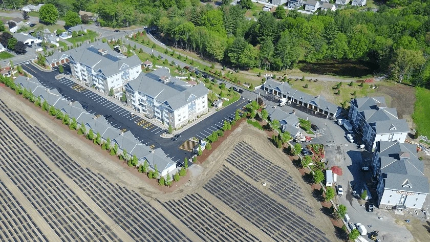 An aerial view of a residential area with solar panels.