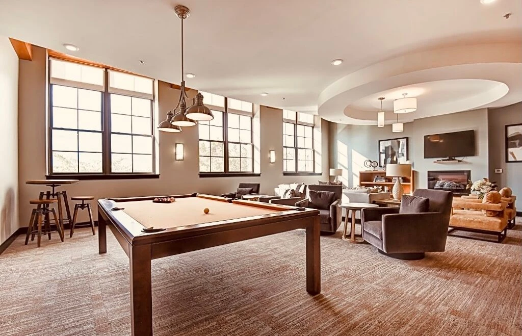 A large living room with a pool table.