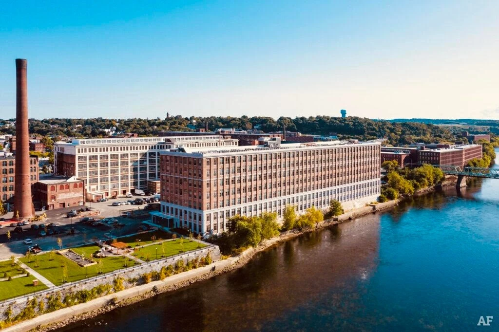 An aerial view of an industrial building near a river.