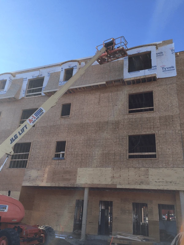A crane is on the side of a building.