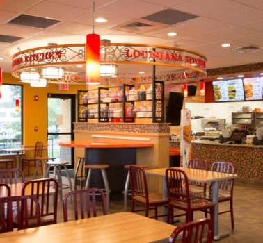 A restaurant with tables and chairs.