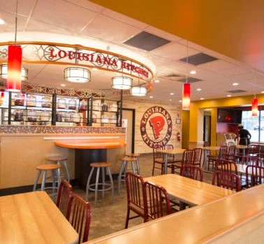 A restaurant with tables and chairs.