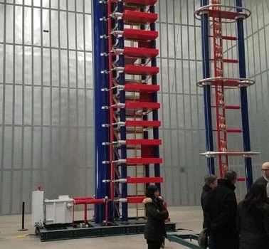 A group of people standing in front of a large machine.