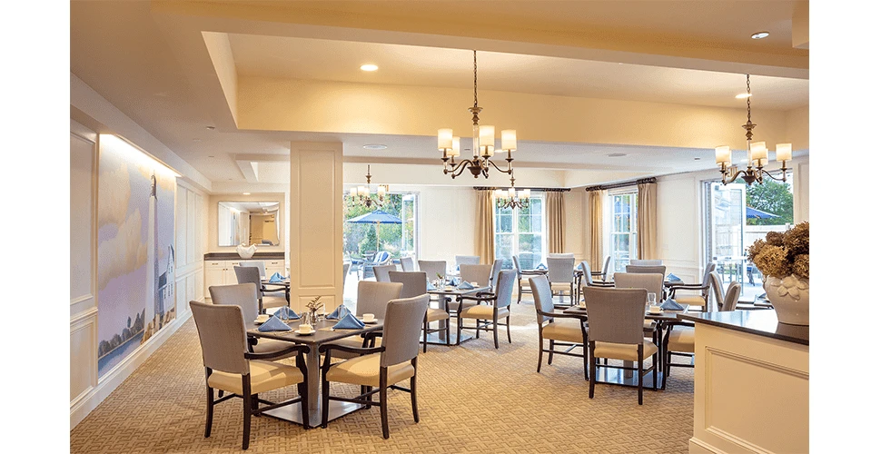 A large dining room with tables and chairs.