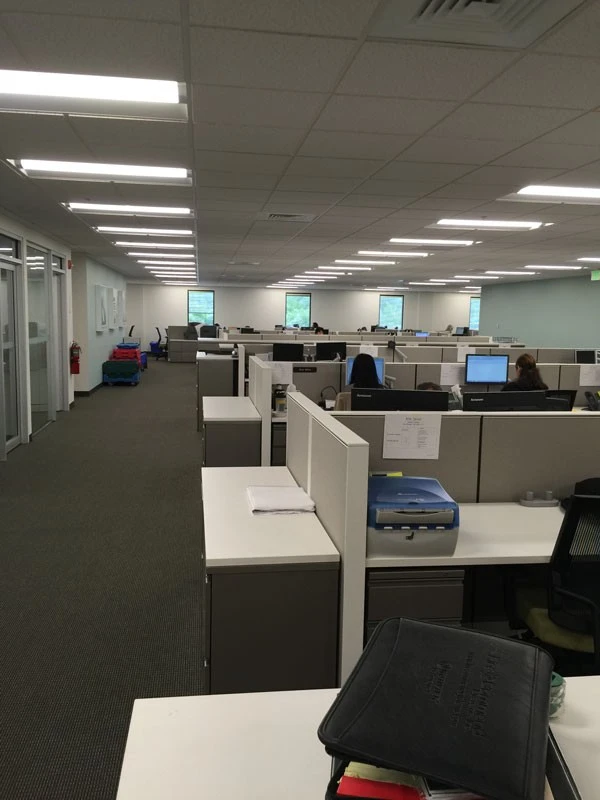 An empty office with a lot of desks.