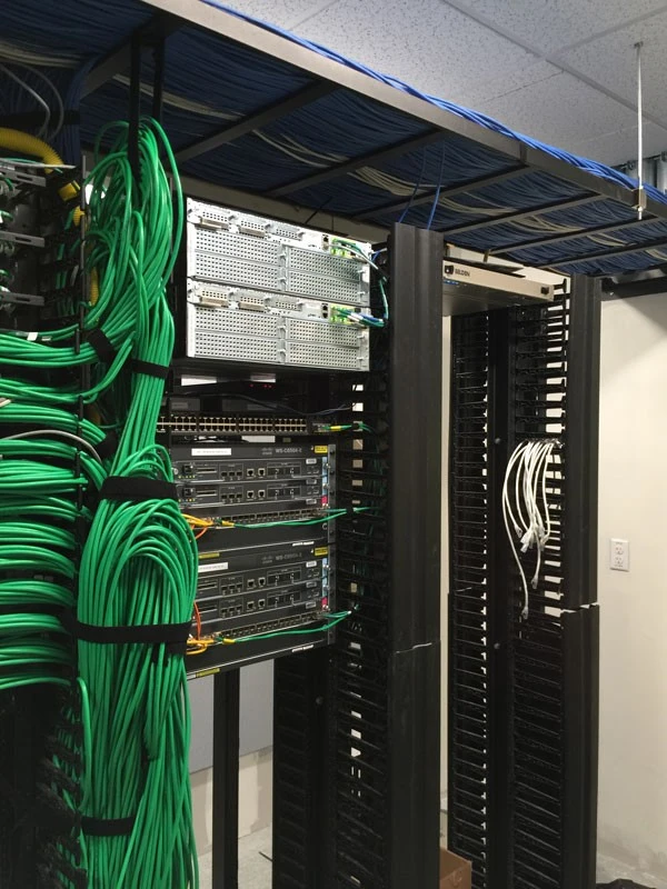 A server room with a lot of wires and cables.