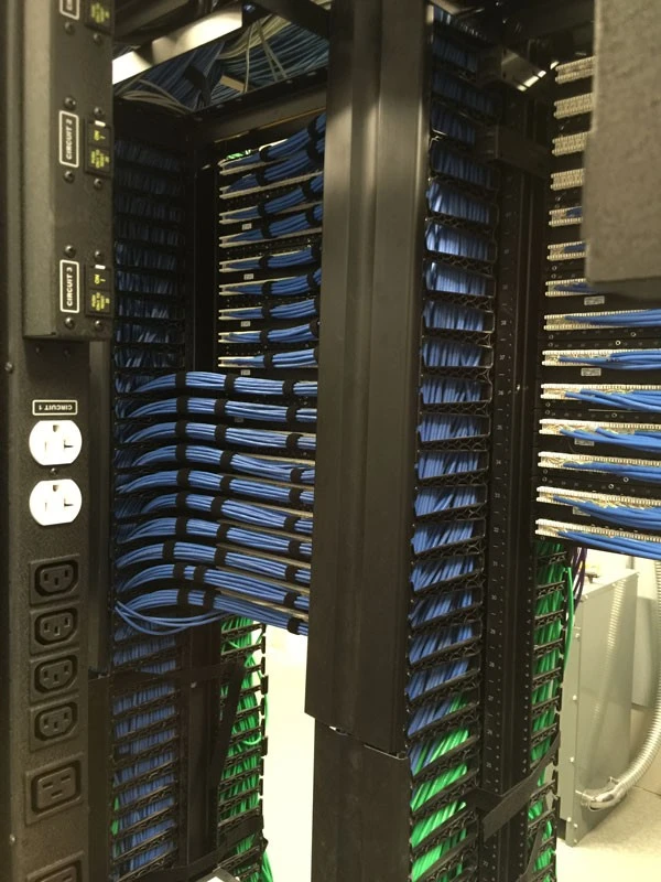 A rack full of wires and cables in a data center.