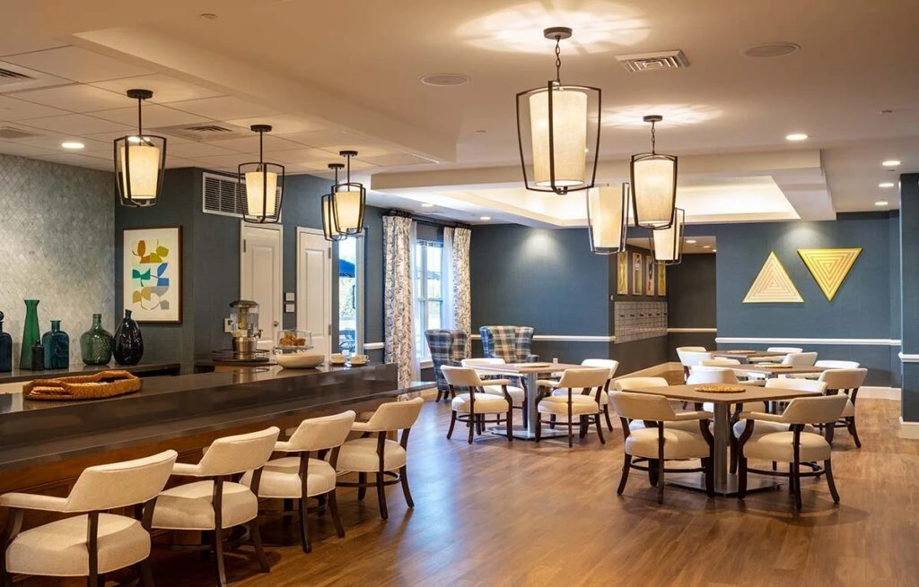 A dining room with blue walls and wooden tables.