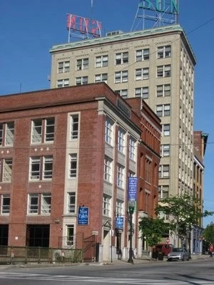 A red brick building with a sign on it.