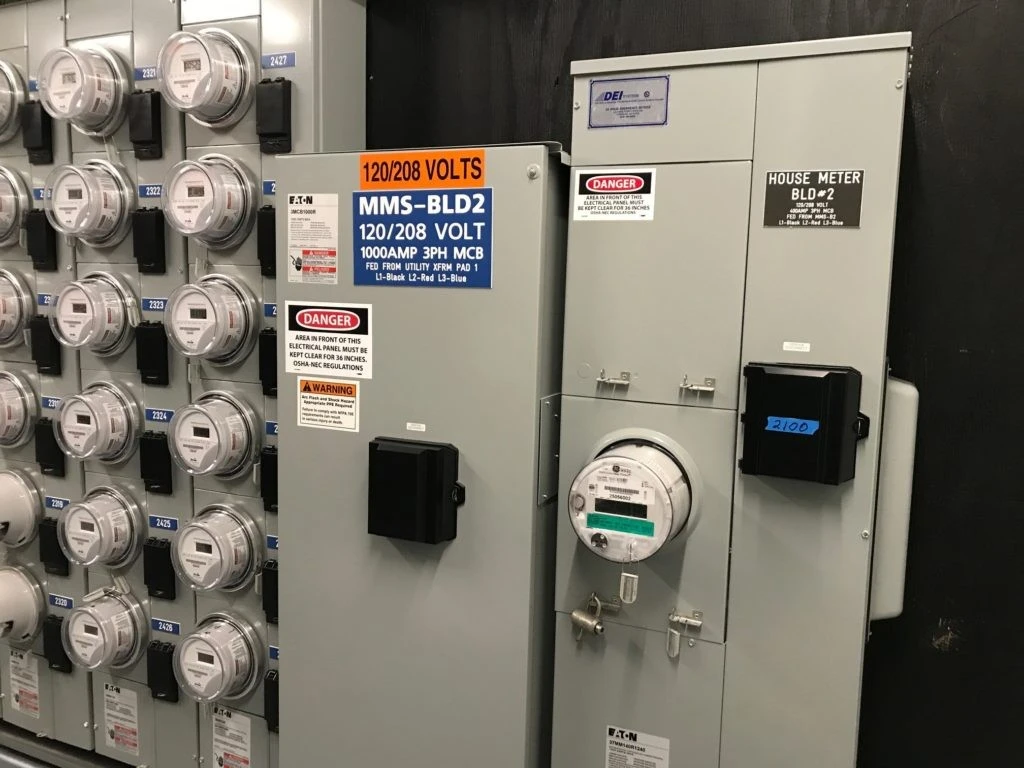 A large electrical panel with a lot of different types of equipment.