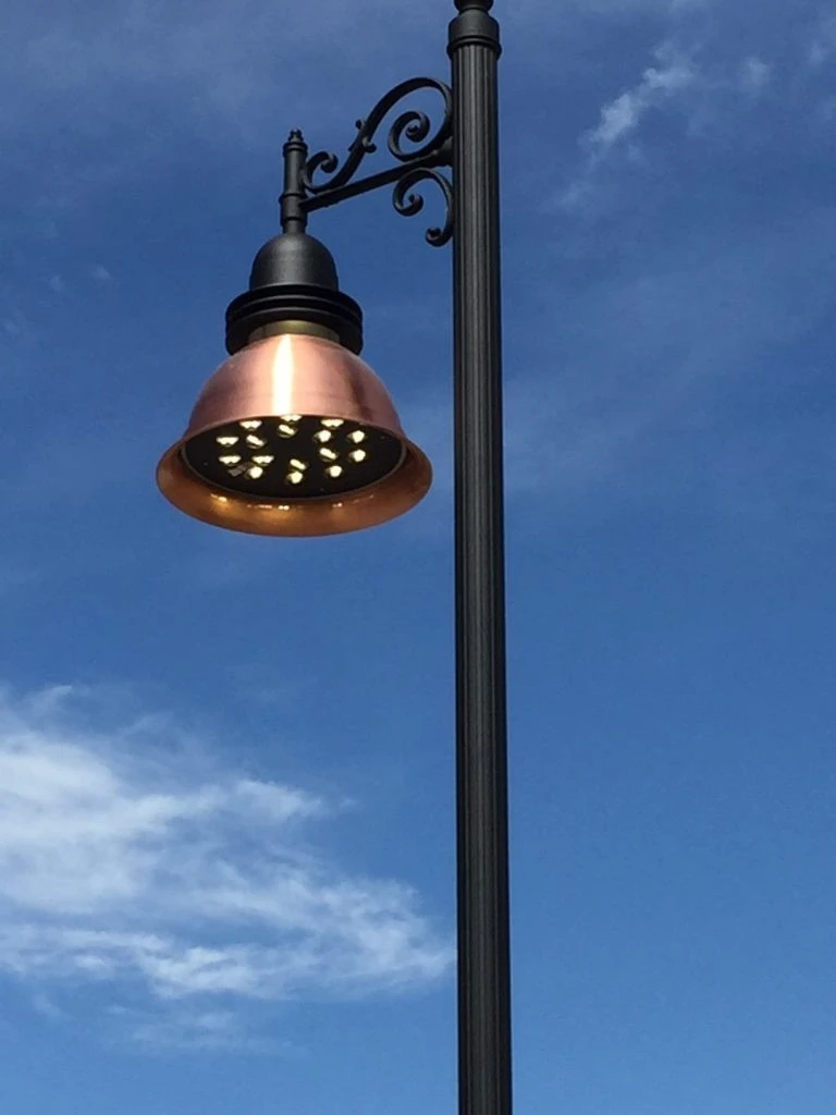 A street light with a blue sky behind it.