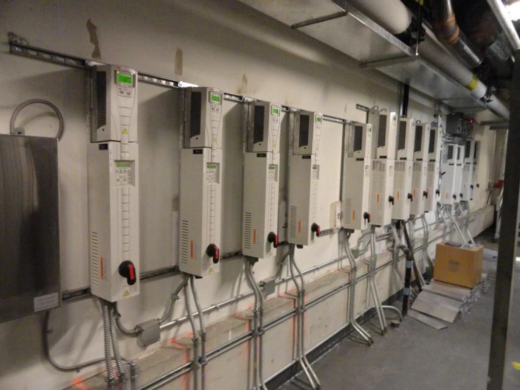 A row of electrical panels in a room.