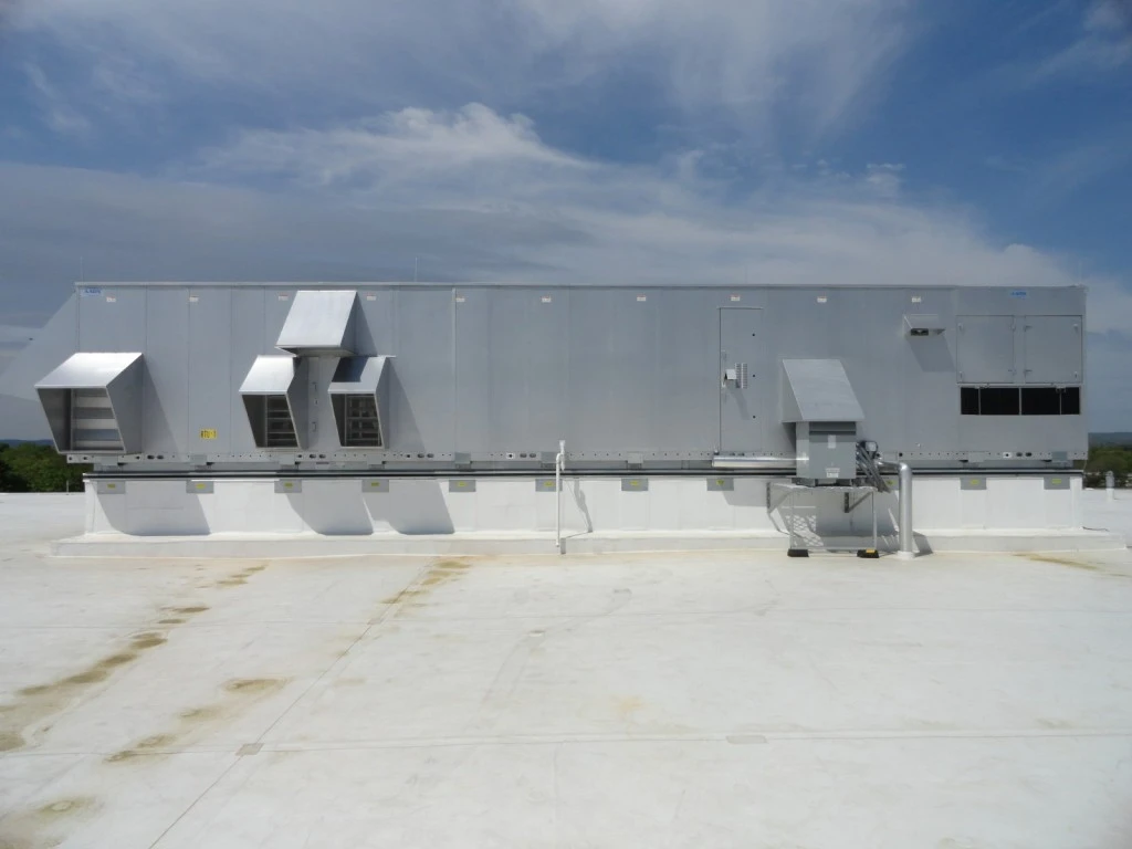 A metal roof with a large air conditioning unit.