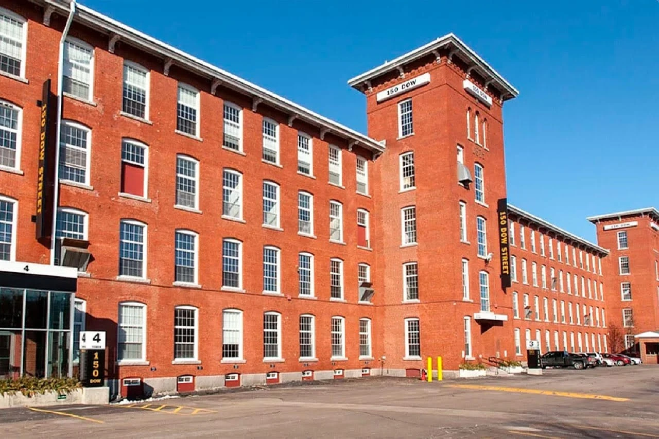 A large red brick building with many windows.