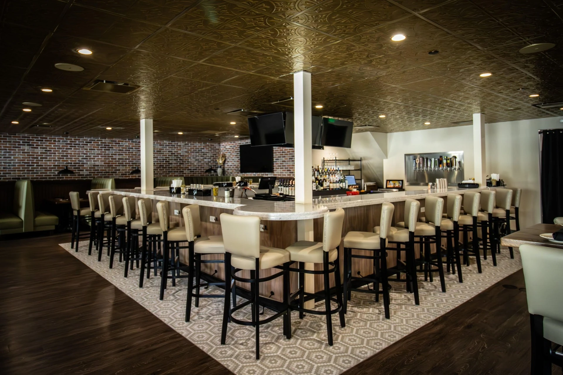 A restaurant with a bar and stools.