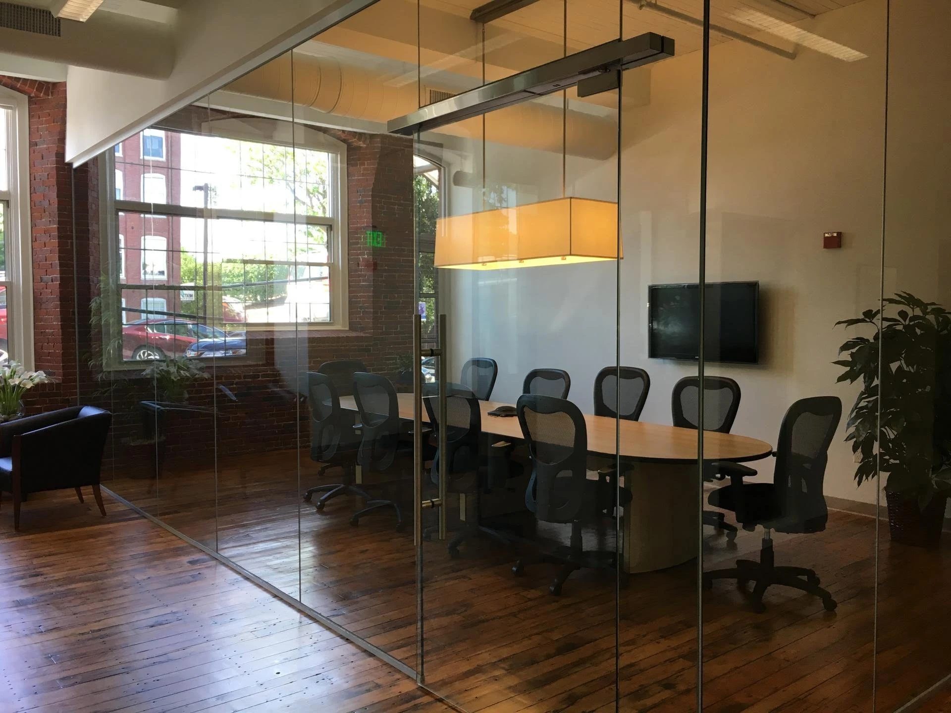A conference room with glass walls and chairs.