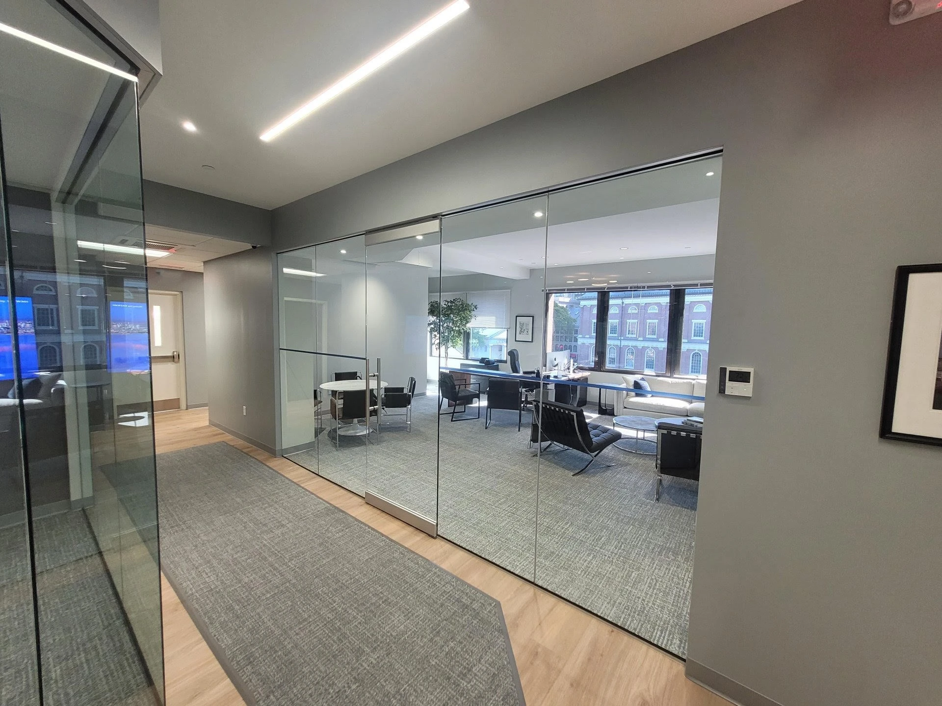 An office with glass walls and a glass door.