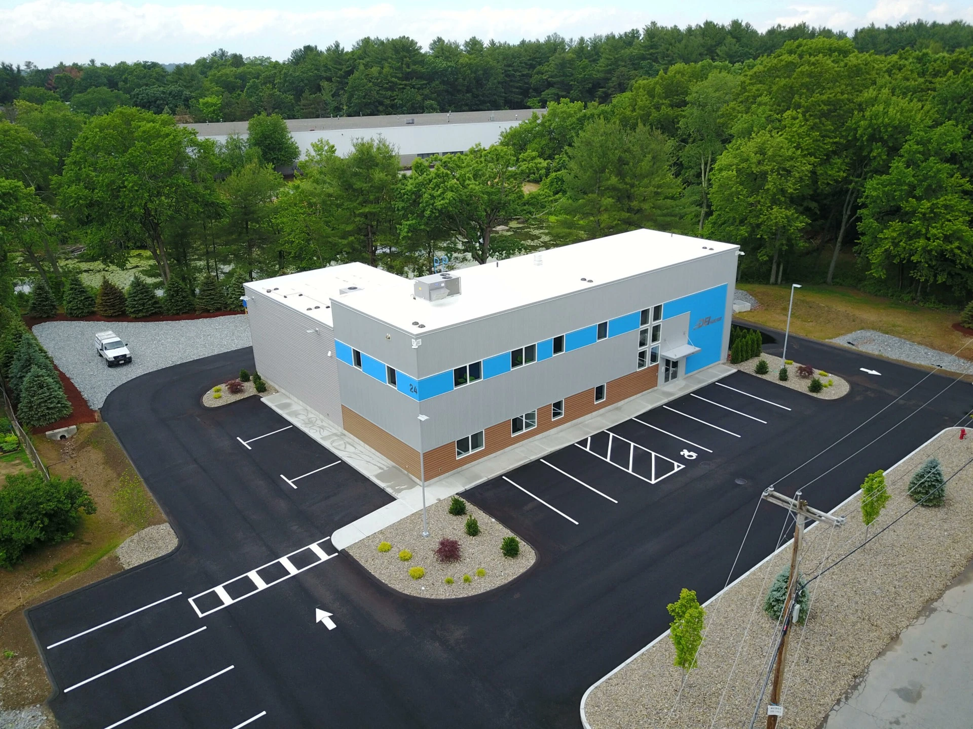 An aerial view of a building in a parking lot.