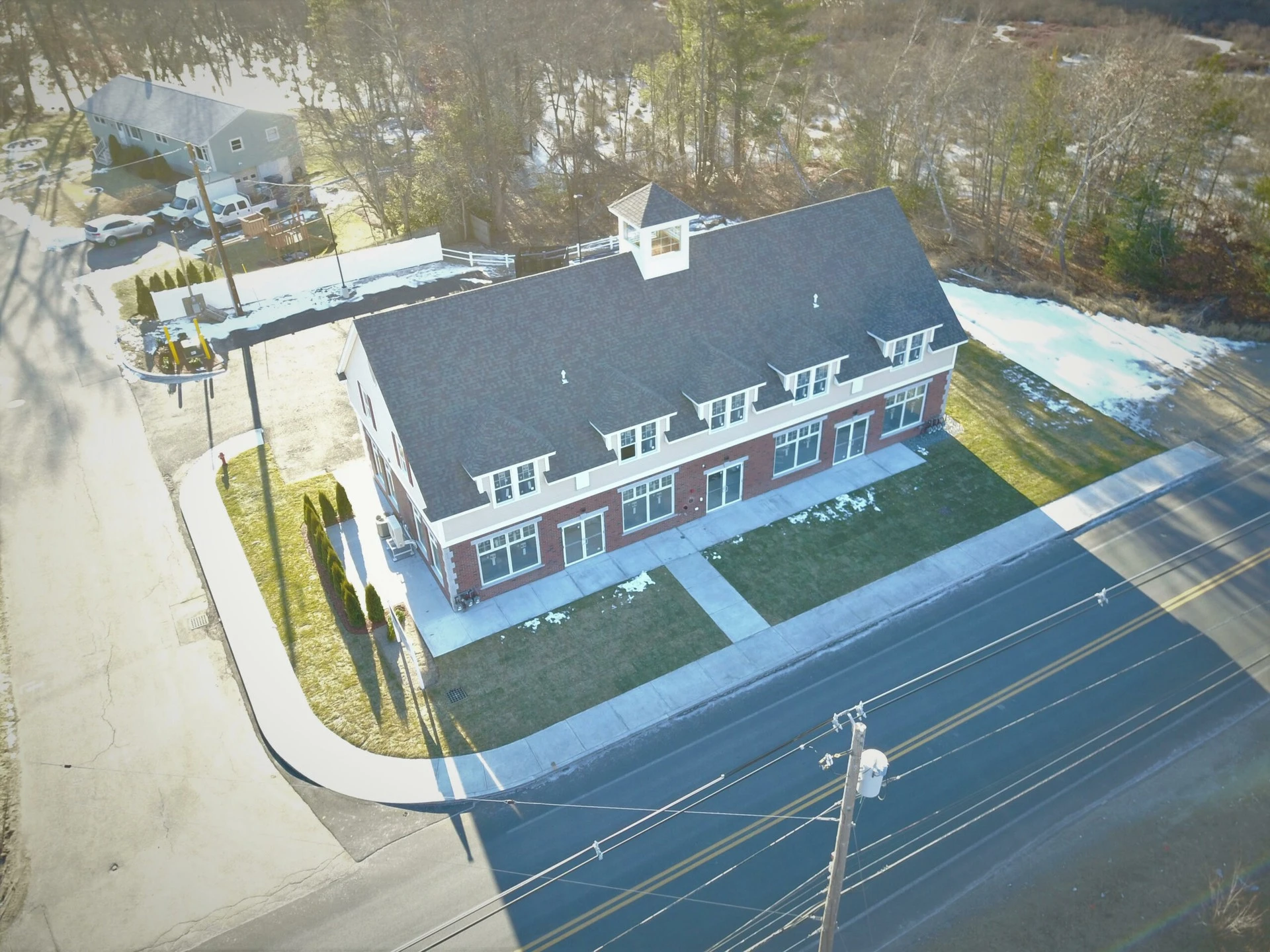 An aerial view of a house on a street.
