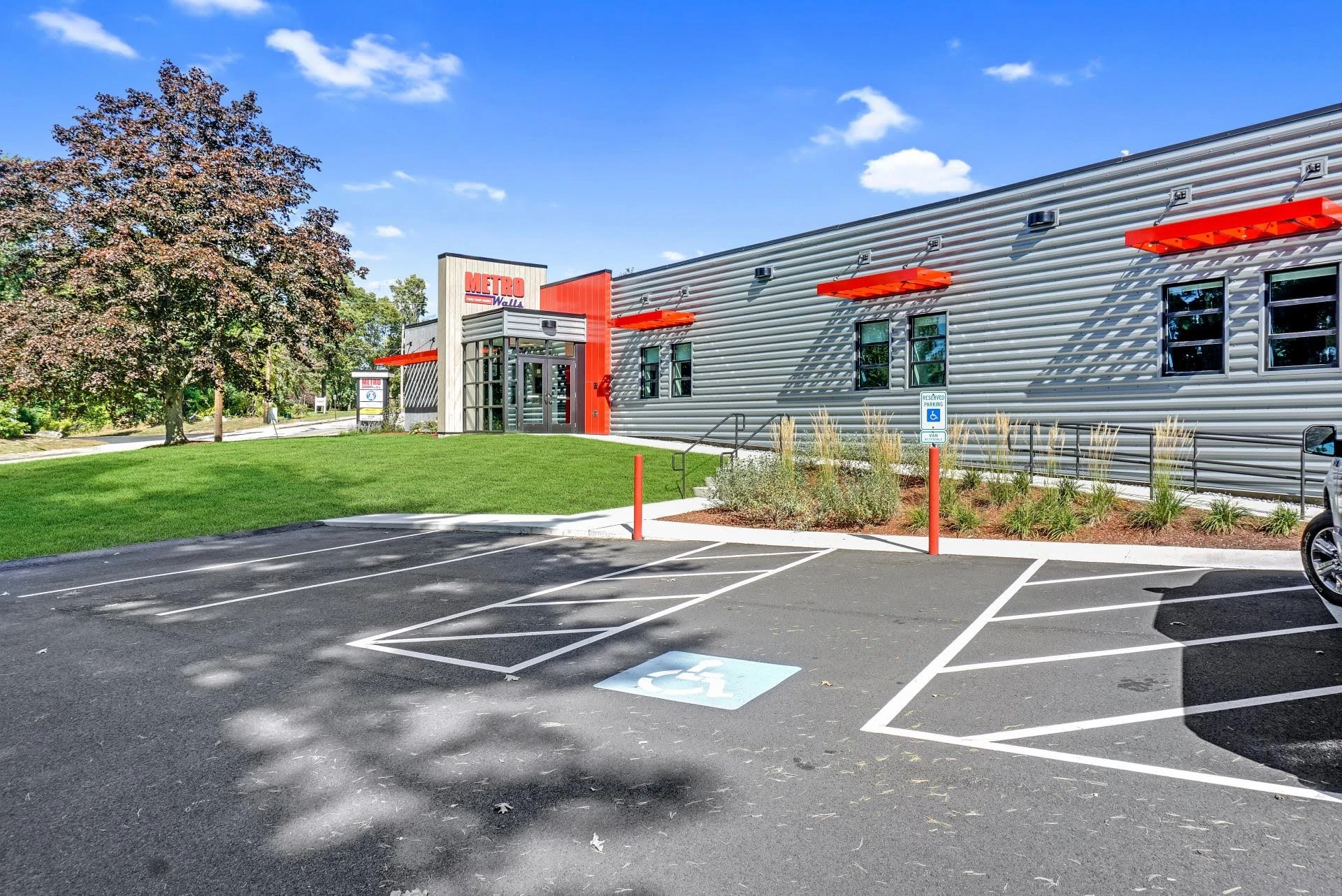 A parking lot with a car parked in front of a building.