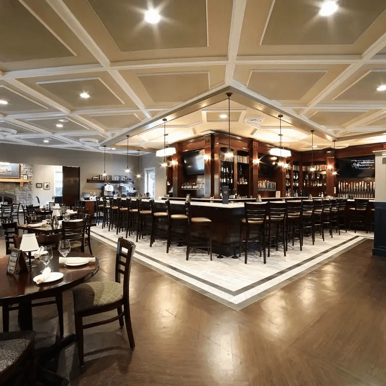 A restaurant with a bar and tables.