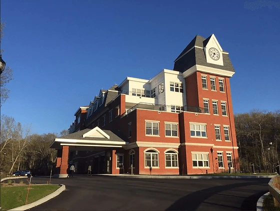 A large red brick building with a clock tower.