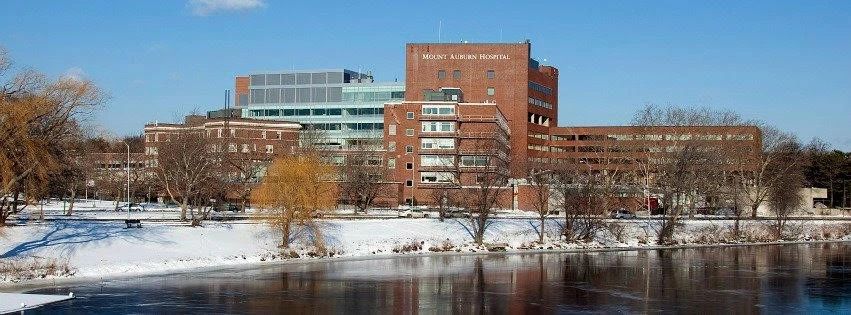 A large building with a river in the background.