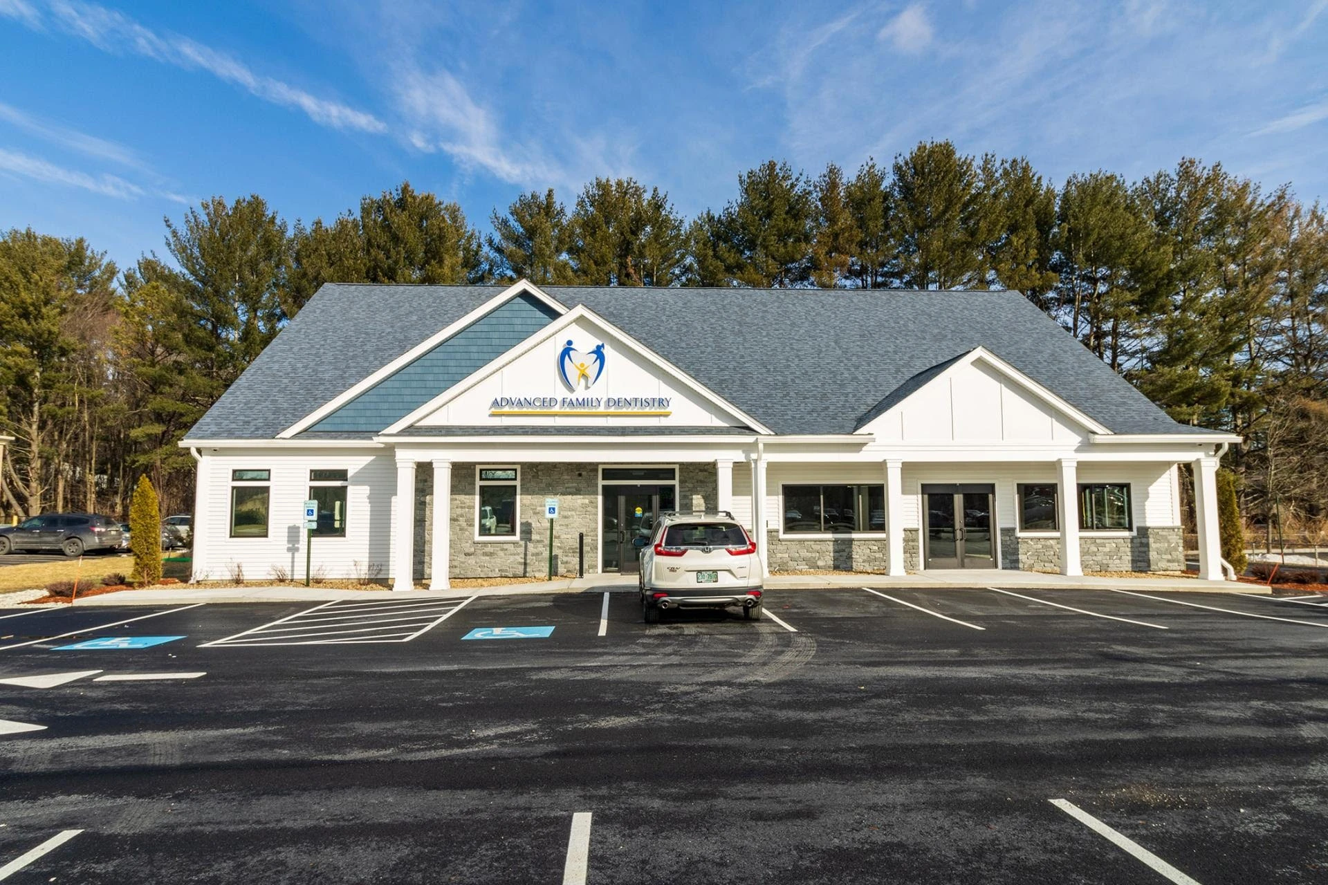 A building with a blue roof and a parking lot.