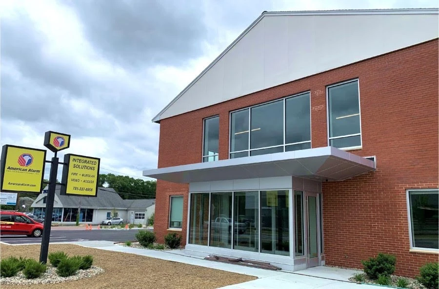 A red brick building with a sign in front of it.