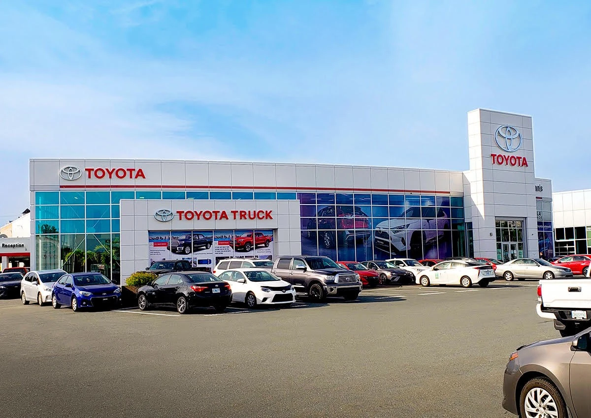 A toyota dealership with cars parked outside.