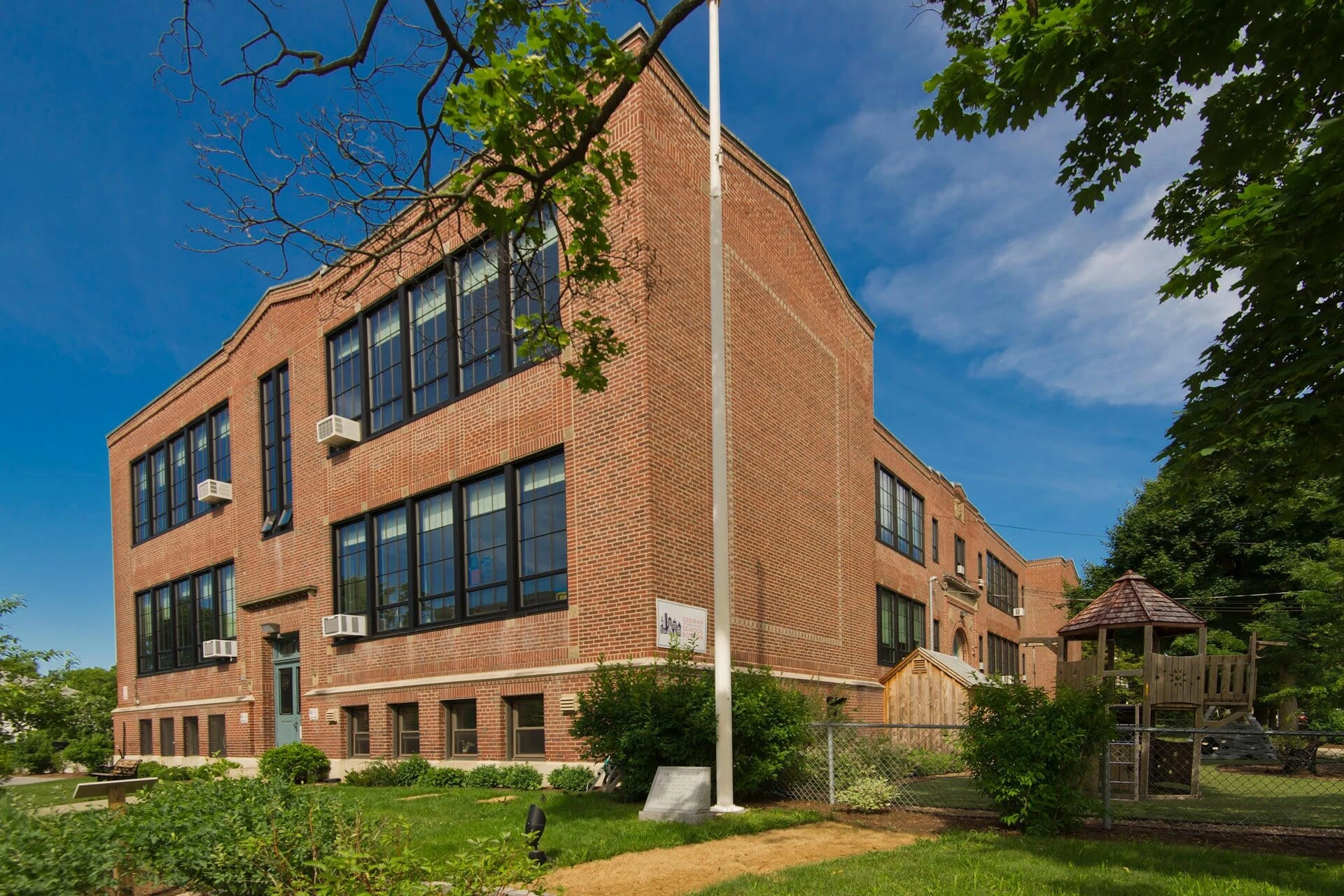 A brick building with a tree in front of it.