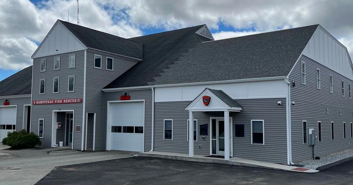 The exterior of a fire station with a gray roof.