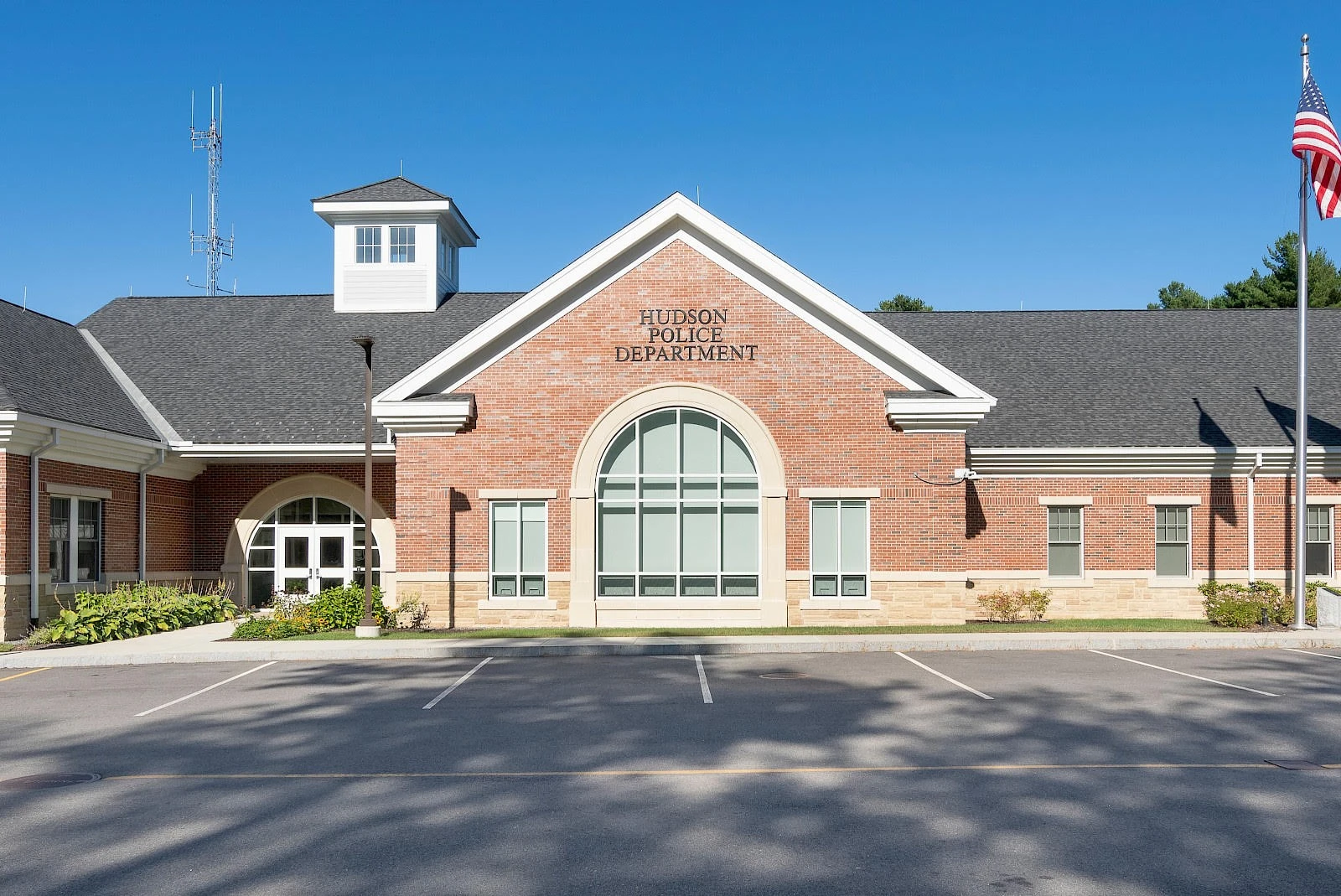 A brick building with an american flag on it.