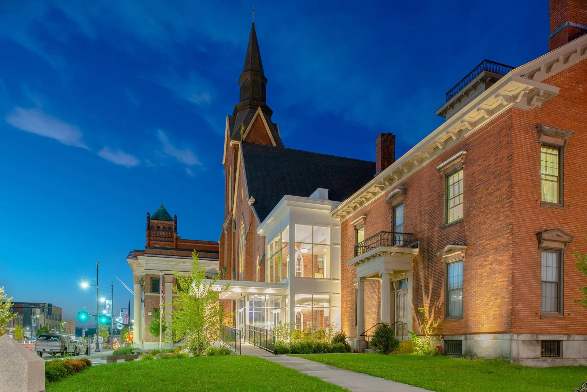 A red brick building with a clock tower in the background.