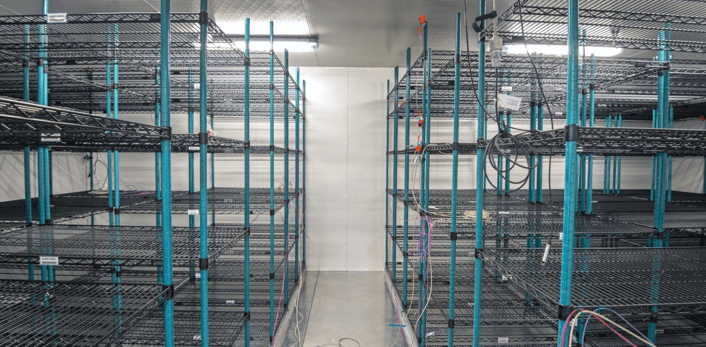A room with many wire racks in it.